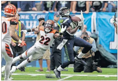  ?? [STEPHEN BRASHEAR/THE ASSOCIATED PRESS] ?? Seahawks wide receiver DK Metcalf makes a catch over Bengals cornerback William Jackson (22) during the first half Sept. 8 in Seattle.