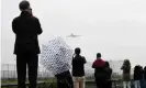  ??  ?? Onlookers take pictures of one of the departing planes. Photograph: Toby Melville/ Reuters