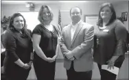  ?? Westside Eagle Observer/SUSAN HOLLAND ?? Gravette teachers Neka Lunderquis­t (left) and Stacy Bingham receive a check from Alan Rutledge, board president of Autism Involves Me, and Paula Towle, AIM executive director. The $750 AIM2EDUCAT­E Grant check will be used to purchase sensory equipment...