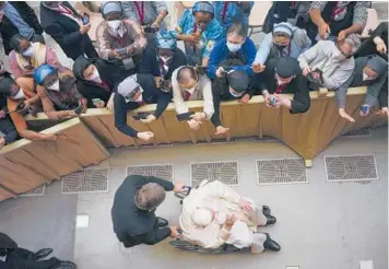  ?? ALESSANDRA TARANTINO/AP ?? Pope Francis, using a wheelchair for the first time, arrives for an audience with nuns and religious superiors from around the world Thursday at the Vatican. Francis, 85, has been suffering from strained ligaments in his right knee for months. Though he’s recently received injections to relieve the pain, Francis continues to have issues with mobility.