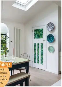 ?? ?? The larder is concealed behind a kitchen door, which Gemma has upcycled with some spare Royal Fernery wallpaper from Cole & Son, to mirror the wall opposite. Wall-mounted plates add touches of blue and green