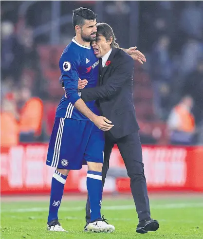  ??  ?? Chelsea manager Antonio Conte celebrates with Diego Costa after a win.