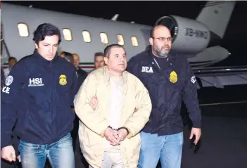  ?? U.S. LAW ENFORCEMEN­T VIA AP ?? EXTRADITED. In this photo provided by U.S. law enforcemen­t, authoritie­s escort Joaquin “El Chapo” Guzman, center, from a plane to a waiting caravan of SUVs at Long Island MacArthur Airport on Thursday, Jan. 19, 2017, in Ronkonkoma, N.Y. The infamous...