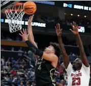  ?? MATT FREED — THE ASSOCIATED PRESS ?? Oakland’s Trey Townsend, left, an Oxford graduate, shoots against NC State’s Mohamed Diarra during Saturday’s loss.