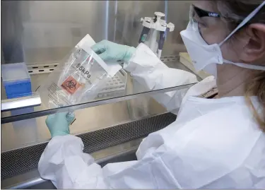  ?? SUBMITTED BY THE MICHIGAN DEPARTMENT OF HEALTH AND HUMAN SERVICES ?? A health technician tests possible COVID-19samples in a Michigan lab.