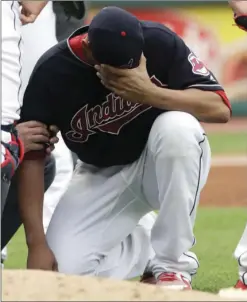  ?? AP PHOTO/TONY DEJAK ?? Cleveland Indians starting pitcher Carlos Carrasco waits on the mound after being hit by a ball on the arm as a trainer takes a look in the second inning of a baseball game against the Minnesota Twins on Saturday in Cleveland. Carrasco left the game after the hit.