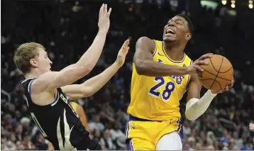  ?? MORRY GASH — THE ASSOCIATED PRESS ?? The Lakers' Rui Hachimura drives against the Bucks' AJ Green during his 16-point, 14-rebound effort on Tuesday.