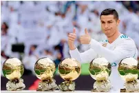  ?? AFP ?? Cristiano Ronaldo poses with his five Ballon d’Or trophies. —