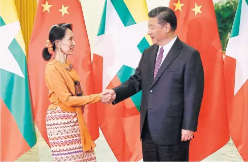  ?? AFP ?? Myanmar State Counsellor Aung San Suu Kyi shakes hands with Chinese President Xi Jinping during a meeting in Beijing in May.