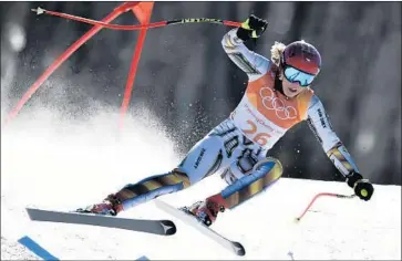  ?? Fabrice Coffrini AFP/Getty Images ?? ESTER LEDECKA races to gold in the super-G. She seemed dumbfounde­d after crossing the finish line.