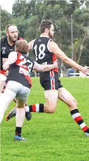  ??  ?? Brendan Hodge kicks into the Nyora forward line as Nilma Darnum’s David Wade tries to tackle him.