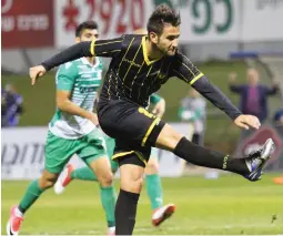  ?? (Adi Avishai) ?? BEITAR JERUSALEM striker Gaetan Varenne (center) fires his team into the lead in last night’s 2-0 victory at Hapoel Kfar Saba in the first leg of the State Cup quarterfin­als.