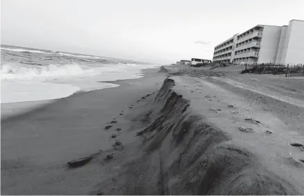  ?? FILE ?? Sand cliffs up to four-feet high along the beach in Kill Devil Hills in 2020.
