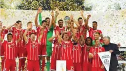  ?? —AFP ?? DORTMUND: Bayern Munich’s players celebrate after winning the German Supercup aginst Borussia Dortmund in Dortmund, western Germany, on Saturday.