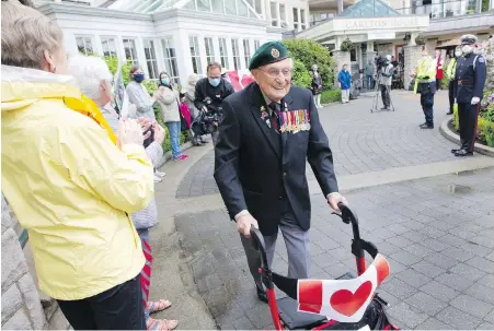  ??  ?? John Hillman, a 101-year-old Second World War veteran, achieves his goal of 101 laps around Carlton House retirement home in Oak Bay.