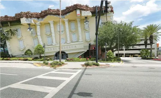  ?? JOE BURBANK/ORLANDO SENTINEL ?? The story behind the inverted look of WonderWork­s Orlando’s exterior involves a tornado experiment by Professor Wonder in the Bermuda Triangle. It ends, the story goes, on Internatio­nal Drive.
