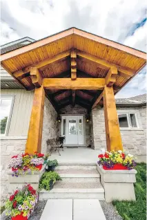  ??  ?? A pine post-and-beam entrance welcomes you to this two-bedroom bungalow by Corvinelli Homes, a finalist in the category of custom home, 2,400 square feet or less.