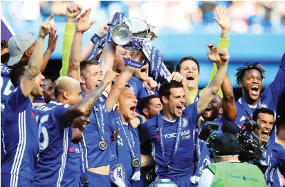  ??  ?? Chelsea players led by John Terry celebrate with the trophy after winning the 2016/2017 English Premier League title yesterday