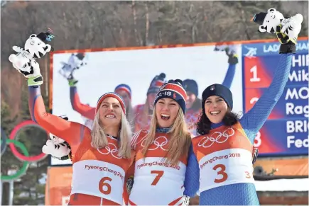  ??  ?? Ragnhild Mowinckel (6), Shiffrin and Federica Brignone (3) celebrate their medal finishes. MICHAEL MADRID/USA TODAY SPORTS