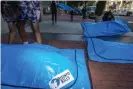  ?? Photograph: Eric Kayne/AP ?? At Facebook’s Washington DC headquarte­rs, activists lay body bags that read “disinfo kills”.