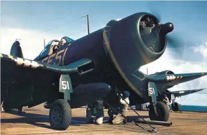  ??  ?? Plane handlers hook a catapult harness up to an F4U-1D Corsair aircraft aboard the Cape Gloucester escort carrier during operations off the coast of Japan on September 8, l945. (Photo courtesy of USMC)