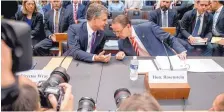  ?? ANDREW HARNIK/ASSOCIATED PRESS ?? Deputy Attorney General Rod Rosenstein, right, and FBI Director Christophe­r Wray, left, arrive to testify before a House Judiciary Committee hearing in Washington on Thursday.