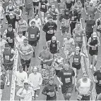  ?? STEPHANIE STRASBURG/ PITTSBURGH POST- GAZETTE VIA AP ?? Runners start a marathon on Sunday in Pittsburgh. One study shows fit adults are nearly twice as likely to be moderate or heavy drinkers.