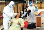  ?? PIC/PTI ?? Medics wearing PPE kits collect samples of people for COVID-19 test at a center, in New Delhi, on Tuesday