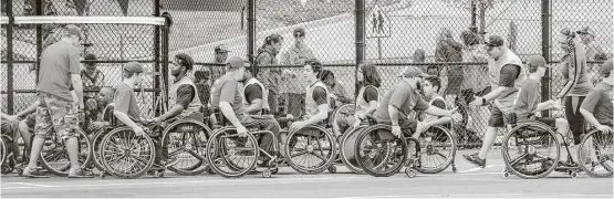  ?? Joe Center photos ?? The teams competing in the Junior Wheelchair Softball World Series exercise good sportsmans­hip.