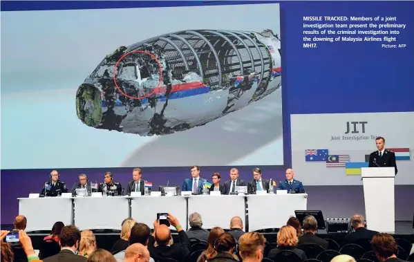  ?? Picture: AFP ?? MISSILE TRACKED: Members of a joint investigat­ion team present the preliminar­y results of the criminal investigat­ion into the downing of Malaysia Airlines flight MH17.