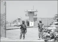  ?? AP/KHALID MOHAMMED ?? Iraqi soldiers stand guard at the Abu Ghraib prison on the outskirts of Baghdad after taking over from U.S. soldiers, in this Sept. 2, 2006, photo.