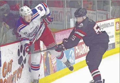  ?? TC MEDIA PHOTO ?? Denver Lynds of the Bearcats gets in the way of Kallum Muirhead of the Western Capitals during action Saturday night at the RECC. The Bearcats held on for a 2- 1 shootout victory.