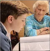  ?? LEE HOWARD THE DAY ?? Casey Hurtgen, 13, reads his biography Tuesday to partner Carol “Poody” Maynard, 89, at StoneRidge Senior Living Community. The pair spent six weeks together working on the bio.