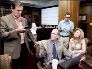  ?? Arkansas Democrat-gazette/karen E. SEGRAVE ?? Bill Murphy (left), with ENR software, checks his smart phone as A.J. Kelly (second from left), Alex Reed and Cynthia Fisher, all with the secretary of state’s office, discuss election-night results Tuesday.