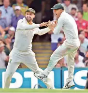  ?? — AP ?? Australia’s Nathan Lyon ( left) and David Warner celebrate the dismissal of England’s James Vince on Thursday.