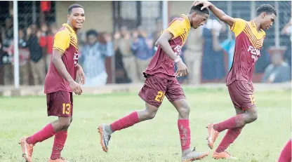  ??  ?? Wolmer’s goalscorer Revaldo Mitchell (centre) celebrates his goal with teammates (left) Shane Reid and Shamar McLean during their 5-0 win over Kingston High in the ISSA-FLOW Manning Cup at Wolmer’s Boys’ School on Friday.