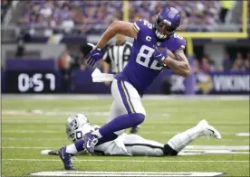  ?? BRUCE KLUCKHOHN - THE ASSOCIATED PRESS ?? FILE - In this Sept. 22, 2019, file photo, Minnesota Vikings tight end Kyle Rudolph (82) runs from Oakland Raiders cornerback Daryl Worley (20) after making a reception during the first half of an NFL football game in Minneapoli­s.