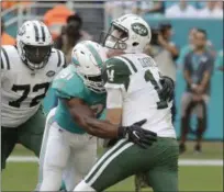  ?? LYNNE SLADKY - THE ASSOCIATED PRESS ?? Miami Dolphins defensive end Cameron Wake (91) sacks New York Jets quarterbac­k Sam Darnold (14), during the first half of an NFL football game, Sunday, Nov. 4, 2018, in Miami Gardens, Fla. New York Jets offensive tackle Brandon Shell (72) is on the left.