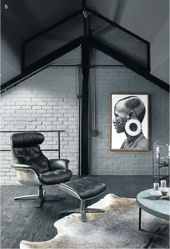  ??  ?? 5 5 The top level of the three-storey space is the chill area. From the cowhide on the floor to the artwork, this room is inspired by the African landscape. An Eames lounger and stool invite you to sit and relax.