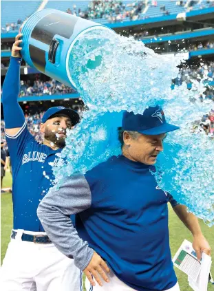  ?? Frank Gunn/The Canadian Press via AP ?? Q Toronto Blue Jays’ Kevin Pillar douses Jays manager John Gibbons after the Blue Jays defeated the Houston Astros, 3-1, Wednesday in Toronto. The Blue Jays announced the long-expected news that Gibbons would not be returning next season before their home finale. Toronto wraps up the season with a three-game road series against Tampa Bay this weekend.