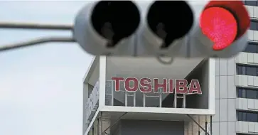  ?? — Reuters ?? Under probe: The Toshiba Corp building in Tokyo. External board members of the company are calling for change in both the board and management.