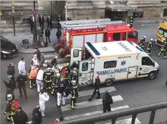  ?? The Associated Press ?? An unidentifi­ed wounded person is loaded into an ambulance in Paris on Friday. A knife-wielding man shouting “Allahu akbar” attacked French soldiers on patrol near the Louvre Museum in what officials described as a suspected terror attack.