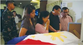  ?? (Reuters) ?? PHILIPPINE PRESIDENT Rodrigo Duterte (second right) consoles parents of a slain soldier who was killed by members of the NPA rebels, in Davao, on Saturday.