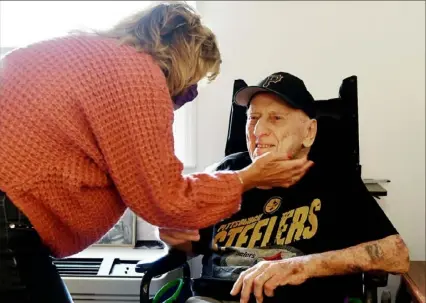  ?? Pittsburgh Post-Gazette ?? Cherrie Rastoka, 64, of Bentleyvil­le, visits her father, Ernest Flick, 91, on Thursday at The Residence at Hilltop in Carroll, Washington County. It was the first time Ms. Rastoka had visited her father in his room at the facility.