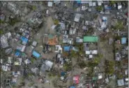  ?? JOSH ESTEY — CARE VIA AP ?? Seen from a drone Praia Nova Village, one of the most affected neighbourh­oods in Beira, razed by the passing cyclone, in the coastal city of Beira, Mozambique, Sunday. Families are returning to the vulnerable shanty town following cyclone high winds and rain. More than 1,000 people are feared dead in Mozambique four days after a cyclone slammed into the southern African country.