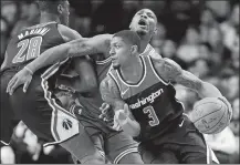  ?? MICHAEL DWYER/AP PHOTO ?? Bradley Beal of the Wizards (3) drives past Marcus Smart of the Celtics, behind, during the first quarter of Monday’s game.