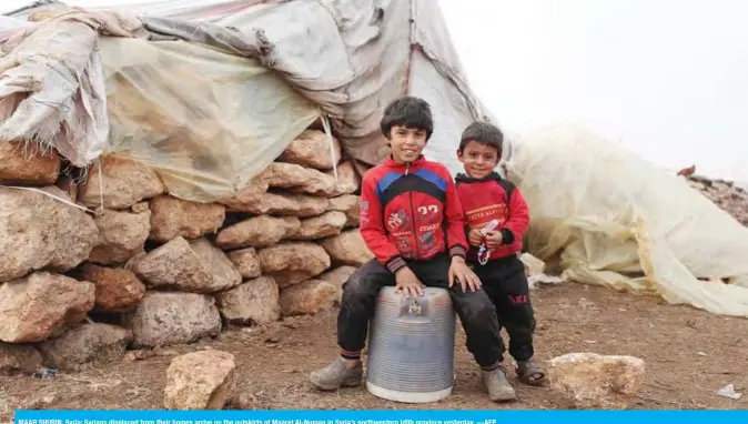  ?? —AFP ?? MAAR SHURIN, Syria: Syrians displaced from their homes arrive on the outskirts of Maaret Al-Numan in Syria’s northweste­rn Idlib province yesterday.