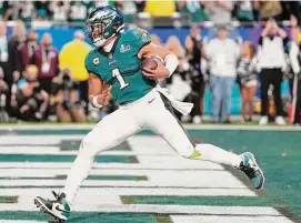  ?? Ashley Landis/Associated Press ?? Eagles quarterbac­k Jalen Hurts (1) scores a touchdown against the Chiefs during the first half of Super Bowl 57 on Sunday in Glendale, Ariz.