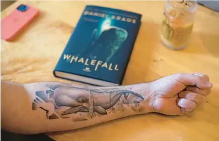  ?? ?? Kraus shows a tattoo of a sperm whale on his left arm.