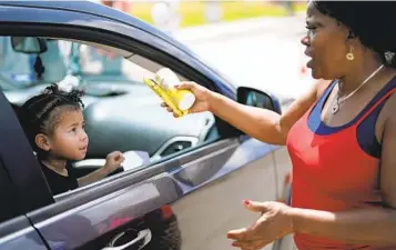  ?? DAVID J. PHILLIP AP ?? Katherine Gibson-Haynes helps distribute baby formula during a drive Saturday in Houston. Parents seeking formula are running into bare shelves in part because of supply disruption­s and a safety recall.